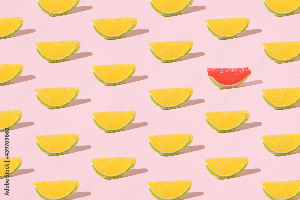 Lemon and watermelon jelly candies with sugar crumbs. Minimal pattern on a pink background. Lemon and watermelon jelly candies with sugar crumbs. Minimal pattern on a pink background.