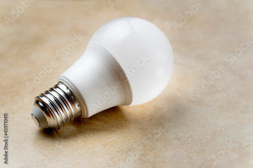 white LED lamp with normal thread on light brown background with copy space on the right