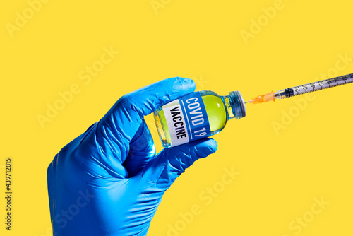 person prepares a covid-19 vaccine shot photo