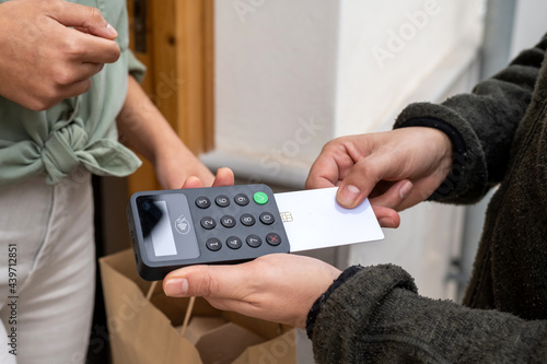 Delivery man receiving payment with credit card photo