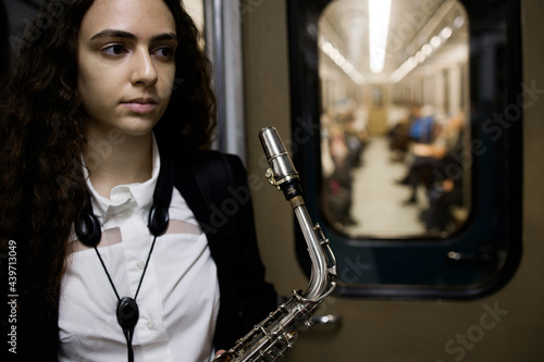 Saxophonist in a subway car  photo