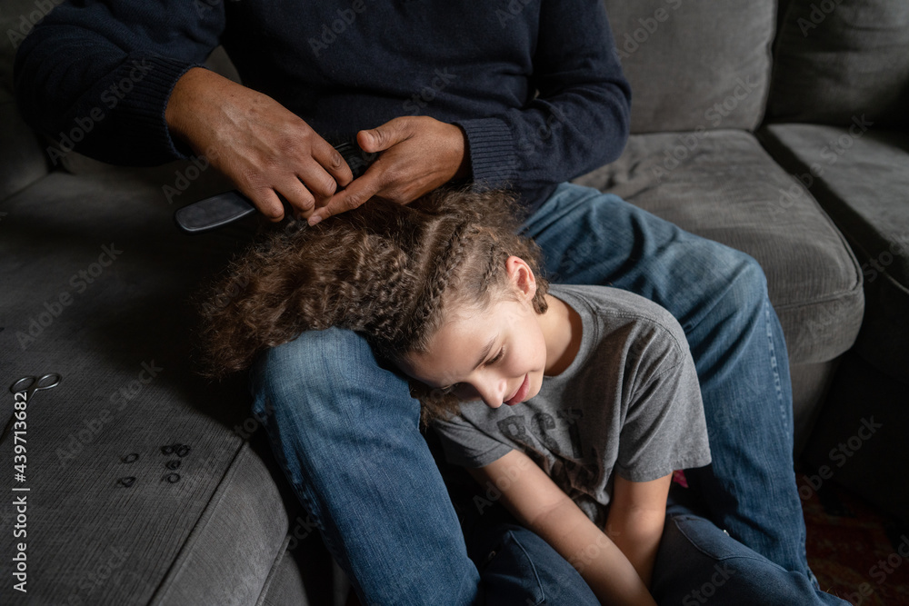 Peaceful scene of boy having braids removed Peaceful scene of boy having braids removed