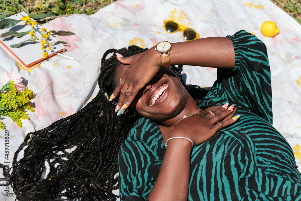 © Lucas Ottone/Stocksy - Woman smiling in the park