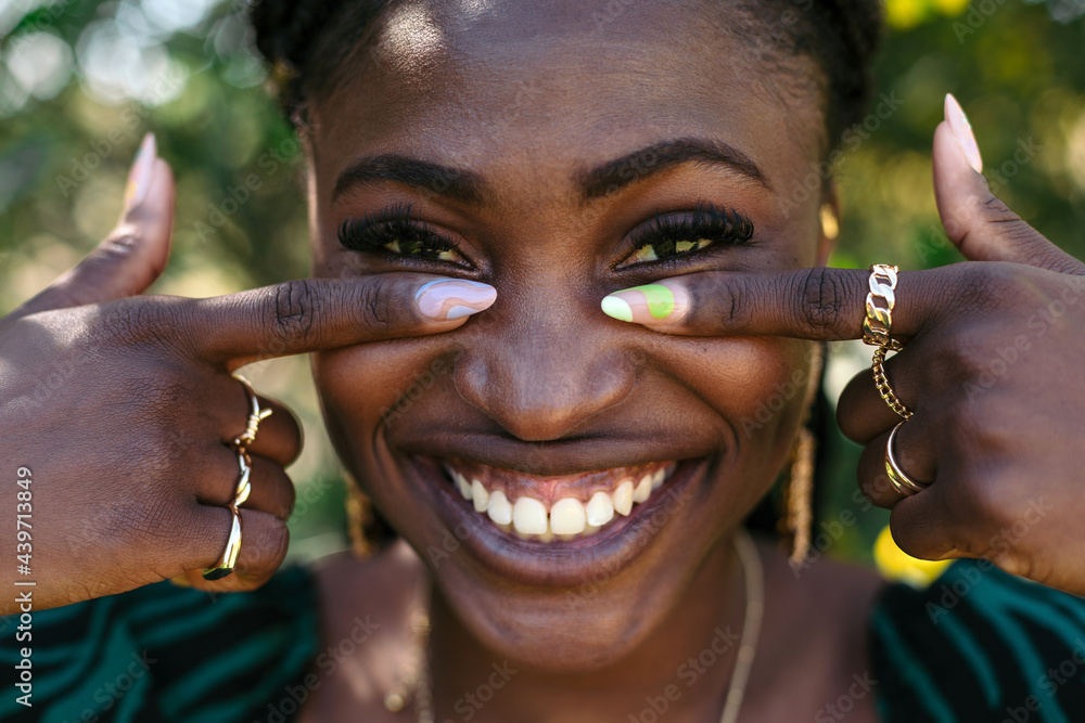 © Lucas Ottone/Stocksy - Black woman with colorful nails