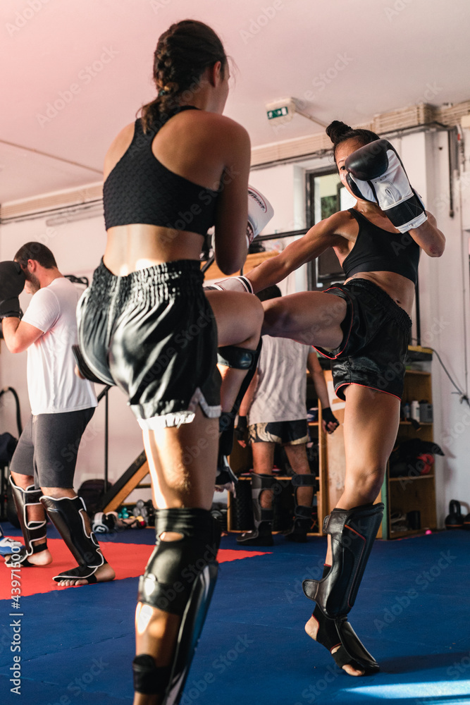 © Irina Efremova/Stocksy - Thai Female Muay Thai Athlete Kicking The Opponent