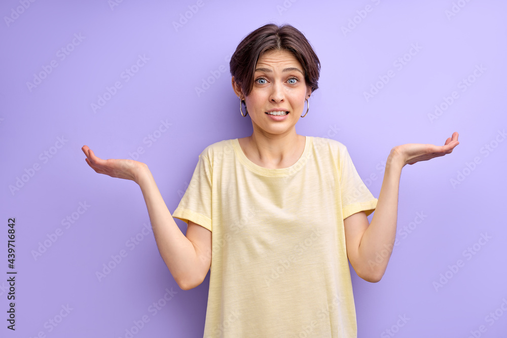 Young woman with open hands asking sorry, isolated on purple background. Oops. beautiful lady ignoring expression said bad wrong thing look at camera empty space Young woman with open hands asking sorry, isolated on purple background. Oops. beautiful lady ignoring expression said bad wrong thing look at camera empty space