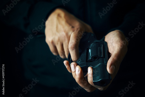 Guy is holding revolver in hands. Firearms close-up. Gun for defense or attack.