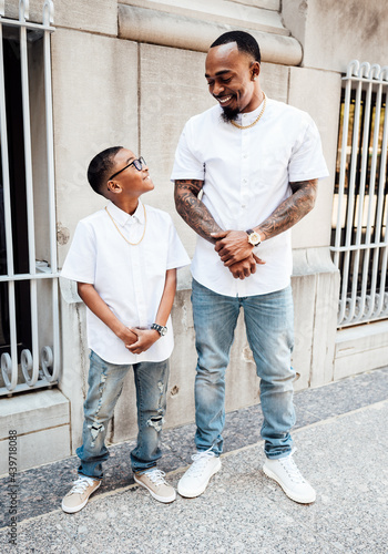 Father and son wearing matching outfits