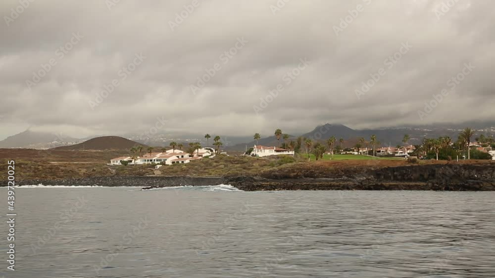 Landscape view from the ocean on the land with buildings and mountains, Spain Landscape view from the ocean on the land with buildings and mountains, Spain