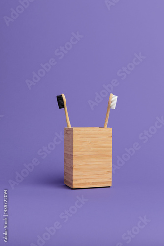 Natural eco toothbrushes in a wooden cup photo