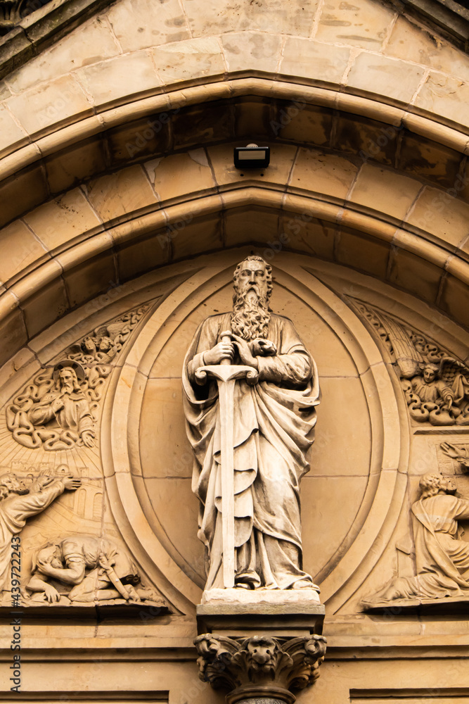 statue of st paul above a church in belfast.