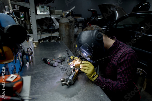 Man welding in his workshop photo