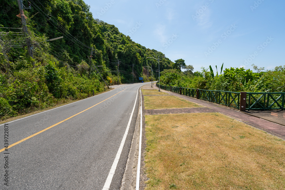 The asphalt road around the phuket island in Summer season beautiful blue sky background at Phuket Thailand.