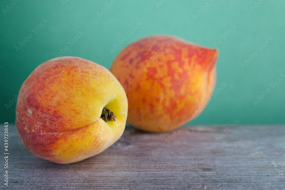 Fresh juicy peaches on a wooden table close up. Summer ripe fruit with vitamins. Fresh juicy peaches on a wooden table close up. Summer ripe fruit with vitamins.