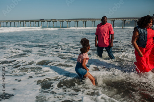 Parents and daughter in deep waves