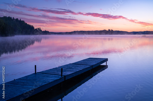 Cottage Dock at Misty Northern Lake on Quiet Colorful Sunrise photo