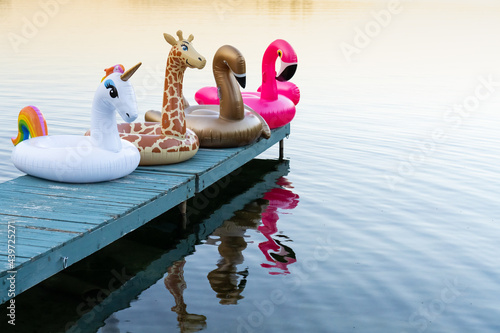 Inflatable Pool Toys on Summer Cottage Lake Dock at Sunset photo