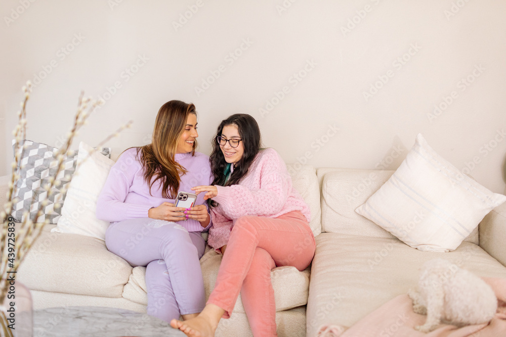 Happy women in colorful home clothes on sofa Happy women in colorful home clothes on sofa