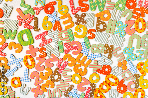 Magnetic letters and numbers on white background photo