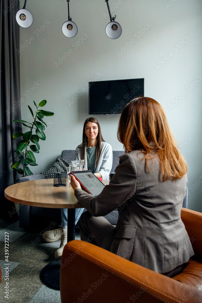 HR specialist talking to candidate during job interview in office HR specialist talking to candidate during job interview in office