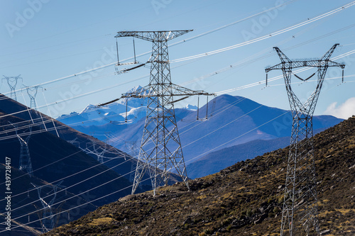 Green energy sources transmission tower and snow mountain photo