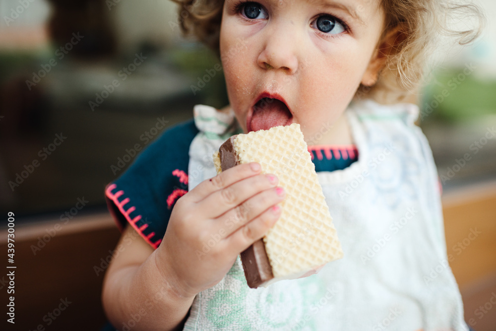 Close up of a young girl eating ice cream outdoors Close up of a young girl eating ice cream outdoors