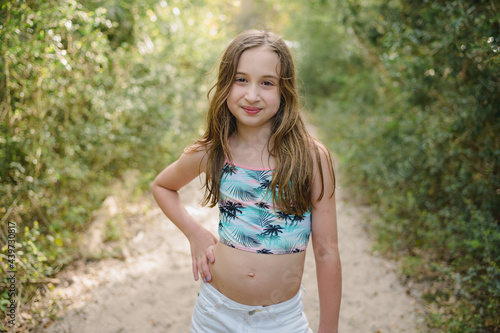 Portrait of a young girl in a swim top and shorts photo