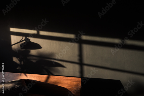 Sunset light on the dark wall in the bedroom