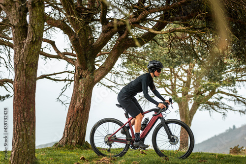 Cyclist riding a bike at forested mountains  photo