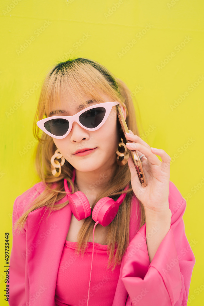 Asian fashion woman with sunglasses and earphones Asian fashion woman with sunglasses and earphones