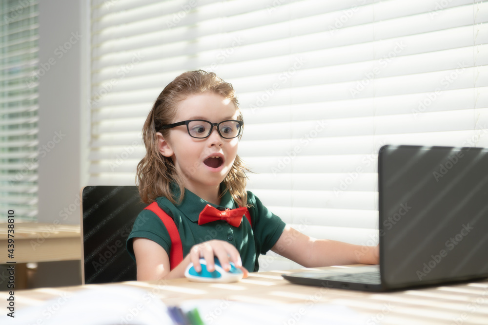 School boy pupil is studying online. Home schooling. Kids distance learning. Cute child using laptop. Education, online study, home studying, homework, schoolboy concept. School boy pupil is studying online. Home schooling. Kids distance learning. Cute child using laptop. Education, online study, home studying, homework, schoolboy concept.