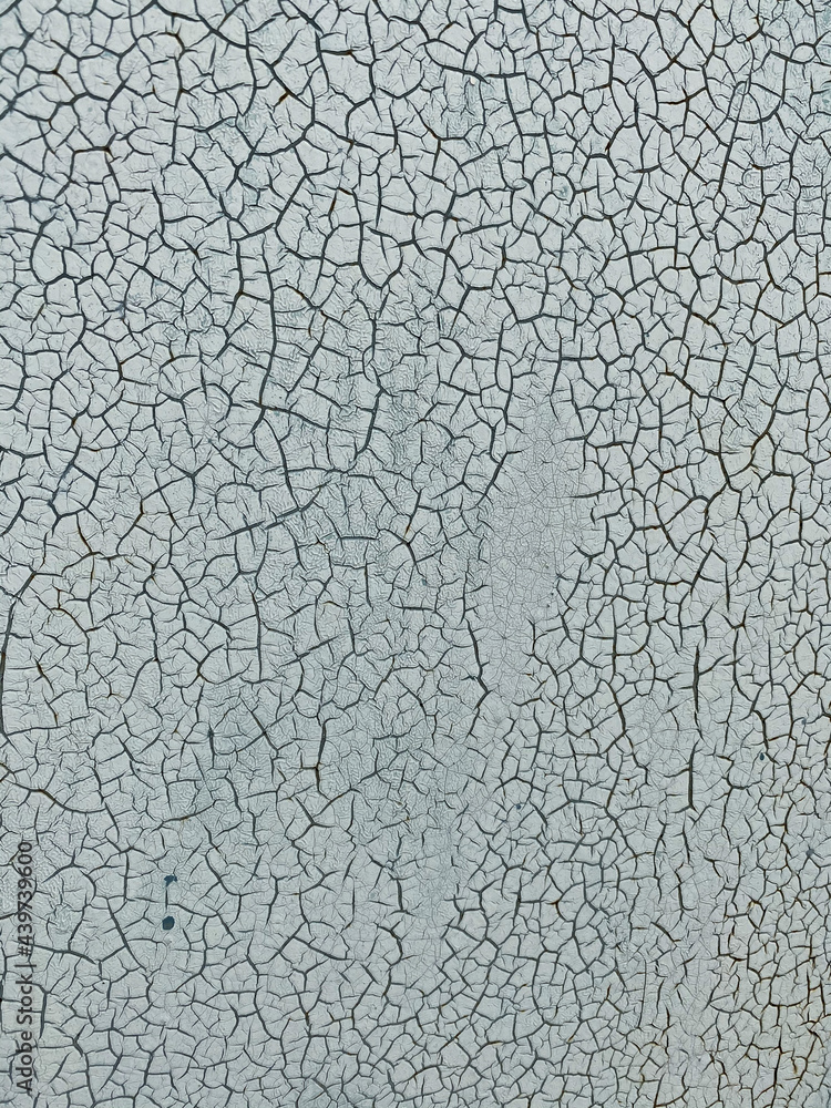 Close-up of a cracked surface. Blue-gray painting Close-up of a cracked surface. Blue-gray painting