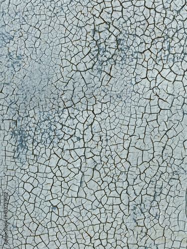 Close-up of a cracked surface. Blue-gray painting