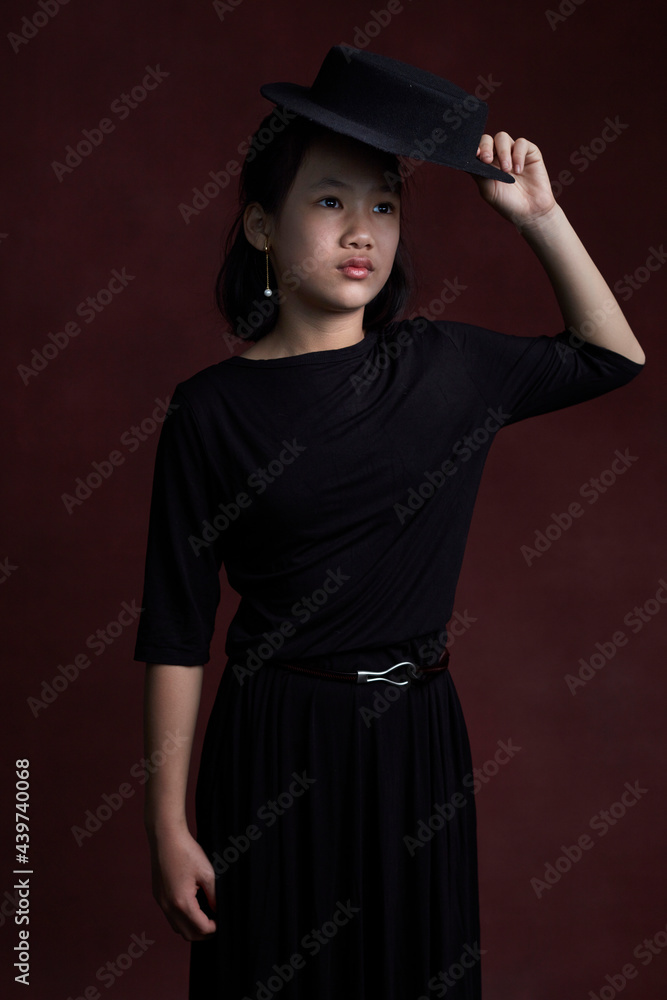 Portrait shot of Asian little girl, wearing black skirt indoors. Portrait shot of Asian little girl, wearing black skirt indoors.