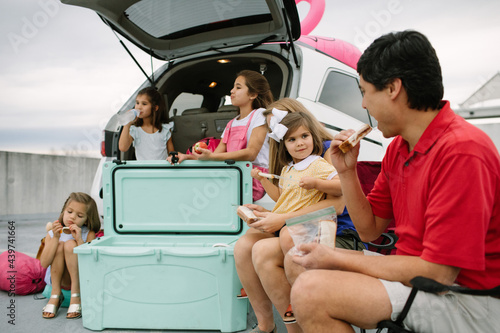 Family Of 6 On A Road Trip, Stopped And Eating A Snack Or Meal