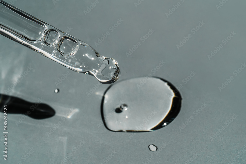 A drop of cosmetic oil falls from the pipette A drop of cosmetic oil falls from the pipette