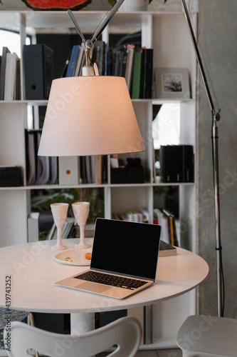 Netbook on white table in coworking space photo