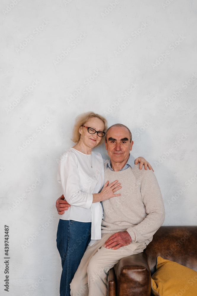 Loving senior couple hugging and looking at camera Loving senior couple hugging and looking at camera