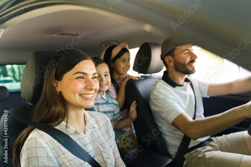 Mom, dad and children enjoying a car ride © AntonioDiaz