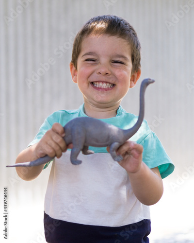 Smiling boy showing his toy photo