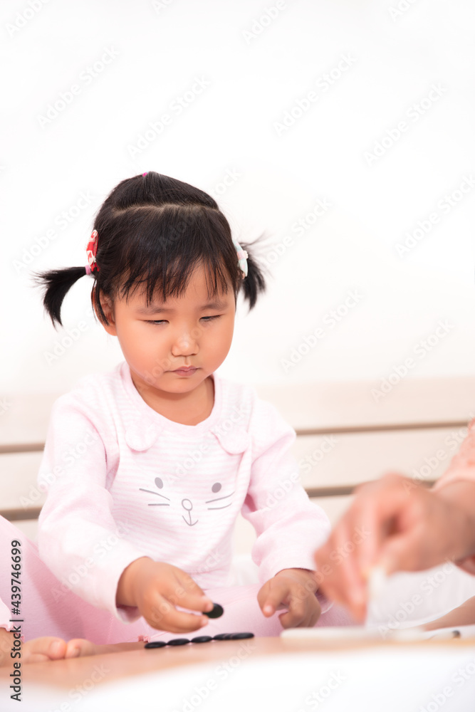Cute girl learning to play go