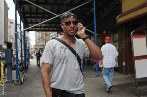 Businessman walking in Manhattan and talking on the phone. photo