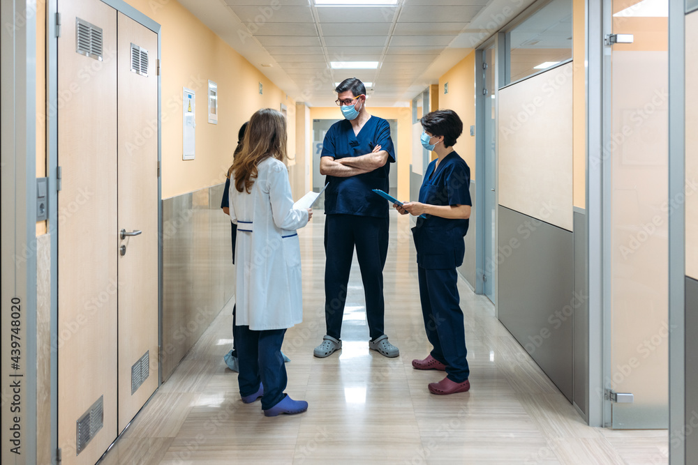 Colleagues discussingin the corridor of a hospital Colleagues discussingin the corridor of a hospital