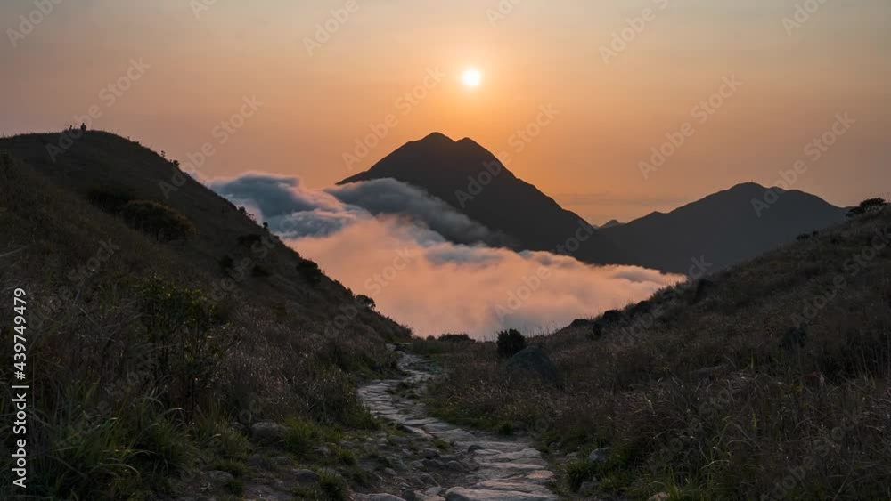 Sunset seen from Sunset Peak, Hong Kong with people walking the stony path in mountain. Hyperlapse. Footage B roll white clouds dense fog move quickly. Hyper lapse fluffy clouds moving. Fog Sea. Sunset seen from Sunset Peak, Hong Kong with people walking the stony path in mountain. Hyperlapse. Footage B roll white clouds dense fog move quickly. Hyper lapse fluffy clouds moving. Fog Sea.
