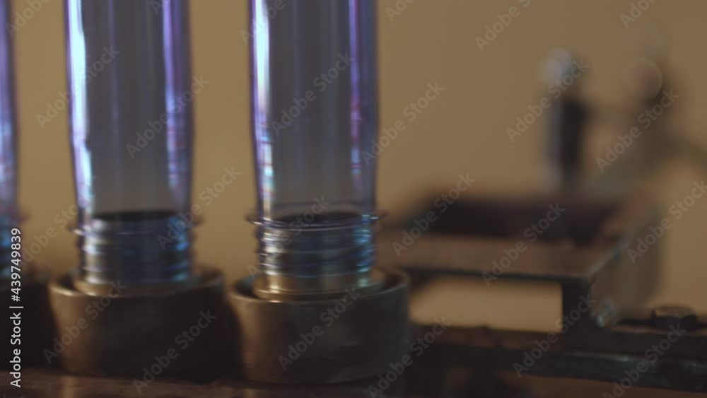 Plastic bottles on a robot in water filling plant Plastic bottles on a robot in water filling plant