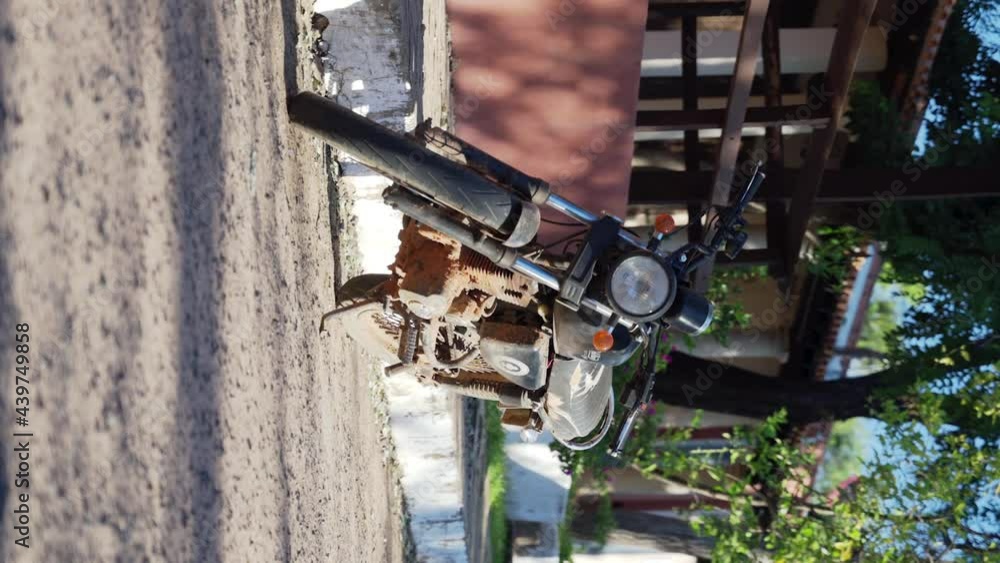 Dirty old motorcycle parking on the street of an old town Dirty old motorcycle parking on the street of an old town