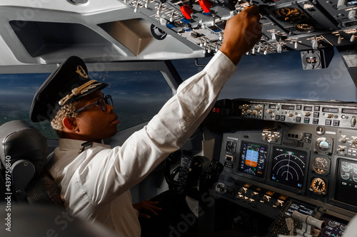 afro american pilot flying a passenger plane photo