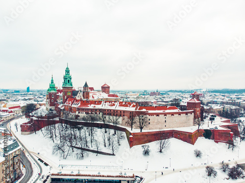 Panoramic view of the old Royal Wawel castle, cathedral in winter season. Wawel is a limestone hill in the center of Krakow upon the Vistula River. Clear white sky in the background. 