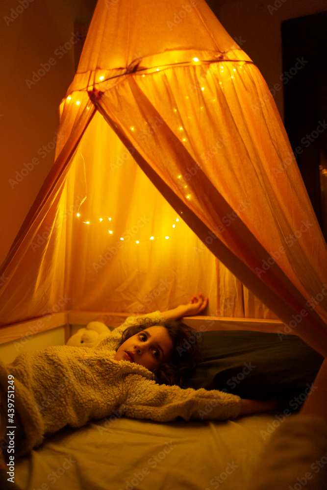 Kid lying on bed under tent Stock Photo Adobe Stock