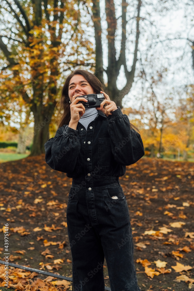 Woman taking Pictures of Autumn with an Old Camera Woman taking Pictures of Autumn with an Old Camera
